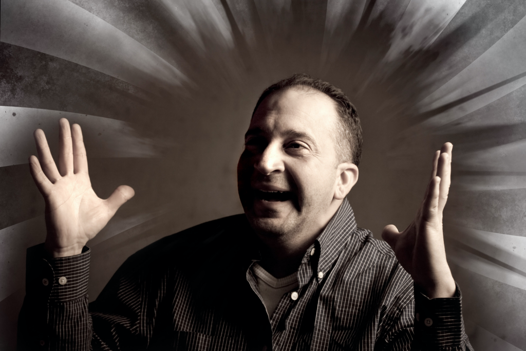 A man shouting with both hands raised
