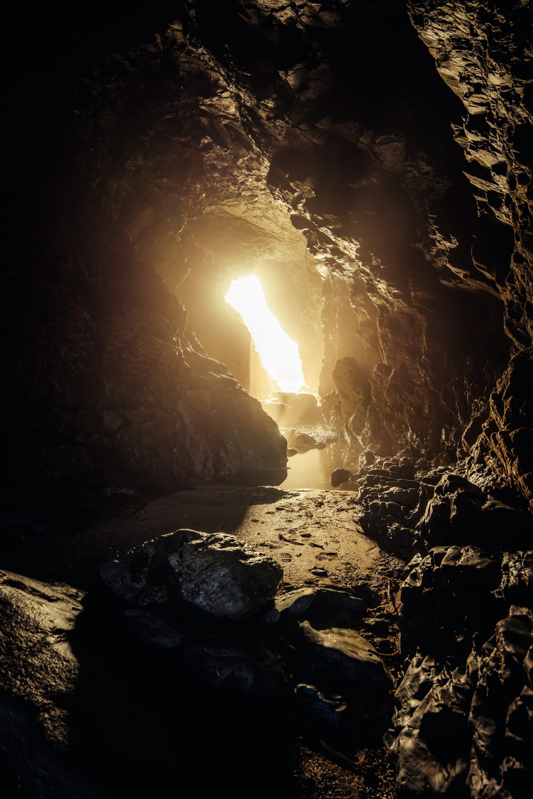 Looking out from a dark cave toward a shaft of light at the opening